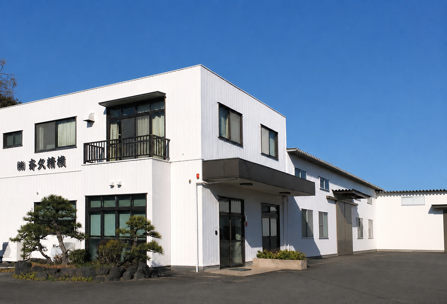 青空の下にある静岡県藤枝市の株式会社斉久精機 本社・工場外観